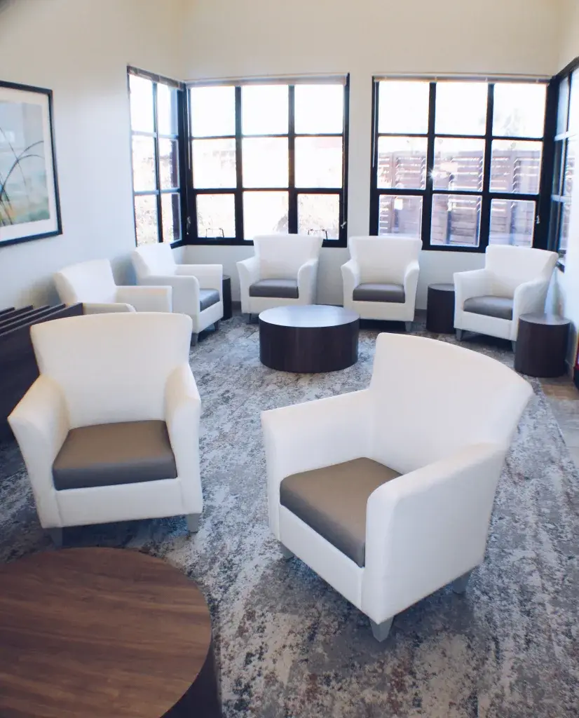 Group Sitting Area with Nice White Chairs and Windows with Natural Light
